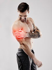 Image showing Sports, looking and a man with arm pain and muscle injury isolated on a grey studio background. Emergency, broken bone and person touching a painful, inflamed and hurt area in the body on a backdrop