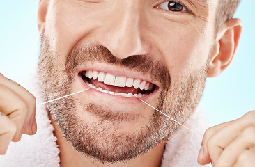 Image showing Dental care, health and man flossing teeth in studio for oral wellness or tooth grooming. Dentistry, healthy and closeup of male model doing fresh, clean and natural mouth routine by white background