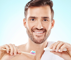 Image showing Smile, portrait or happy man brushing teeth with dental toothpaste for healthy oral hygiene grooming in studio. Eco friendly, smile or male model cleaning mouth with a natural bamboo wood toothbrush