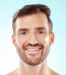 Image showing Face portrait, skincare and man with cream in studio isolated on a blue background. Beauty, dermatology and happy male model with creme cosmetics, lotion and facial moisturizer for healthy skin.