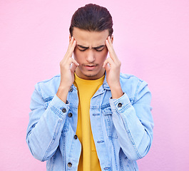 Image showing Depression, stress and man with headache in studio isolated on a pink background. Mental health, anxiety and depressed, unhappy or sad male model with problem, pain or migraine, burnout or fatigue.