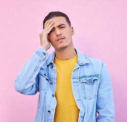 Image showing Stress, portrait and man with headache in studio isolated on a pink background. Mental health, anxiety and face of depressed and sad male model with depression, pain or migraine, burnout or emoji.