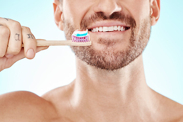 Image showing Smile, mouth or happy man brushing teeth with dental toothpaste for healthy oral hygiene grooming in studio. Eco friendly, zoom or male model cleaning with a smile or natural bamboo wood toothbrush