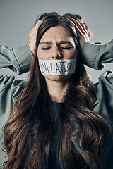 Image showing Woman, tape and mouth with quiet protest, social activism and global economy crisis by background. Inflation, gen z girl and studio backdrop with economic opinion, stress and financial freedom vision
