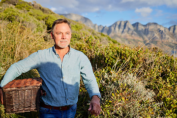 Image showing Picnic, summer and a man in the mountain, walking outdoor in nature for adventure, freedom or recreation. Spring, travel and environment with a male taking a walk in the wilderness alone for hiking