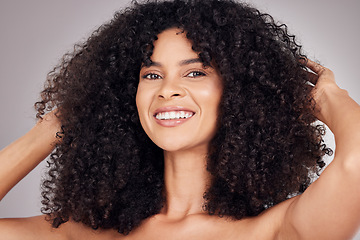 Image showing Portrait, beauty and afro with a model black woman in studio on a gray background for natural hair or skincare. Face, salon or Brazil girl happy with smile for health, beauty or facial treatment
