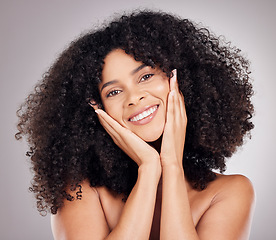 Image showing Portrait, beauty and afro with a model black woman in studio on a gray background for hair or skincare. Face, salon and aesthetic with an attractive young female posing to promote keratin treatment