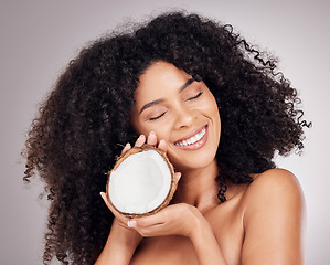 Image showing Beauty, coconut and black woman isolated on studio background for natural skincare, face and hair dream. Afro model or young person sleeping with fruit product or healthy oil benefits for dermatology