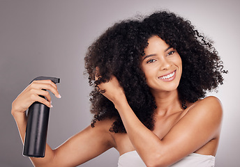 Image showing Face of black woman spray product on hair for natural wellness, growth and shine on gray background. Beauty, luxury salon and happy girl smile with hairspray, cosmetic products and keratin treatment