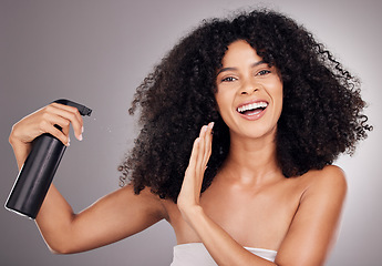 Image showing Portrait of black woman spray on hair for wellness, growth and natural shine on gray background. Beauty, salon and happy face of girl smile with hairspray, cosmetic products and keratin treatment