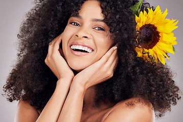 Image showing Skincare, face of black woman or sunflower in hair in studio for spring, luxury spa or sustainable. Aesthetic, beauty facial portrait or girl with plants for natural afro, cosmetics or eco friendly