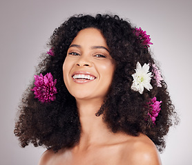 Image showing Portrait, smile or face of black woman with flowers in hair in studio background for spring, sustainable or self care. Natural, beauty facial or girl model with plant for skincare, cosmetic or makeup