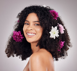 Image showing Portrait, black woman and hair care, flowers and shine with smile, girl and grey studio background. Face, African American female or clean scalp with salon treatment, florals or happiness on backdrop