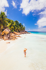 Image showing Woman enjoying Anse Patates picture perfect beach on La Digue Island, Seychelles.