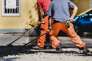 Image showing Asphalt surfacing manual labor.