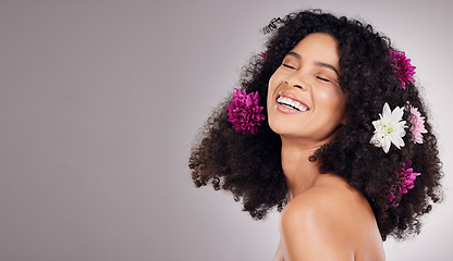 Image showing Black woman, beauty and smile with flower hair in cosmetics or skincare against a gray studio background. Happy African American female model smiling in joyful satisfaction for floral art on mockup