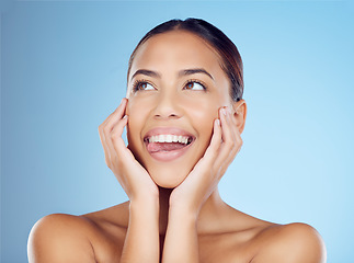 Image showing Woman, tongue out and makeup in studio for beauty, skincare and grooming on blue background space. Emoji, headshot and girl model relax in luxury cosmetic, skin and natural, wellness and treatment