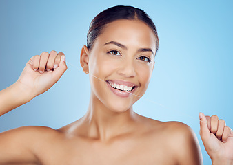 Image showing Floss, dental wellness and portrait of woman in studio for beauty, healthy body and hygiene on blue background. Female model, tooth flossing and cleaning mouth for facial smile, breath or happy teeth