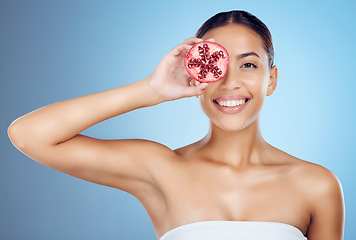 Image showing Pomegranate facial, woman and portrait for beauty, skincare wellness and studio background. Happy model, smile face and red fruit seeds of natural cosmetics, detox nutrition and aesthetic dermatology