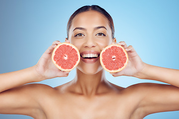 Image showing Grapefruit, woman and smile for beauty portrait on studio background for wellness benefits. Skincare model, diet and citrus fruits for natural detox, healthy nutrition and happy face with vitamin c