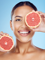 Image showing Grapefruit, portrait and woman cover eyes for beauty on studio background, wellness benefits and smile. Happy model, diet and citrus fruits for natural detox, healthy skincare and face for vitamin c