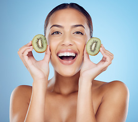 Image showing Kiwi, woman and portrait of smile for skincare, beauty and wellness food on studio background. Happy model, organic green fruits and natural cosmetics for detox, facial benefits and aesthetic glow