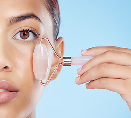 Image showing Woman, closeup portrait and massage with roller, facial product and aesthetic skincare on studio mockup. Young model, crystal stone and wellness for natural cosmetics, rose quartz beauty or face glow