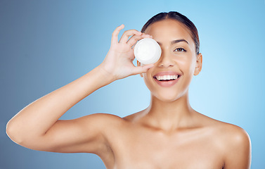 Image showing Beauty product, portrait and face cream with a model holding skincare treatment with mockup. Sunscreen, facial lotion and dermatology wellness of young female with happiness from self care in studio