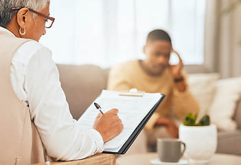 Image showing Man on sofa, therapist writing notes on clipboard for mental health advice and consulting in office. Stress, anxiety and depression, sad person and psychologist in consultation room with patient.