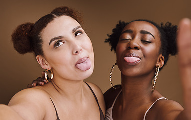 Image showing Beauty, friends and tongue with selfie of black women for social media, skincare and fashion. Happy, silly and picture with funny face of girl for internet, comic and crazy in brown background studio