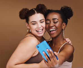 Image showing Fashion, selfie and friends with phone smile on brown background for wellness, cosmetics and makeup. Influencer, happy and black women on smartphone for social media content, picture and online post