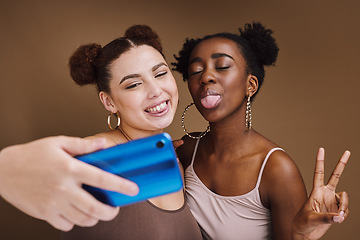 Image showing Fashion, selfie and friends with phone with peace sign on brown background for wellness, cosmetics and makeup. Jewellery, happy and girls smile on smartphone for social media, picture and online post