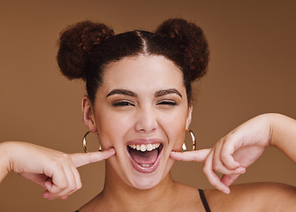 Image showing Woman, portrait or fun cheek fingers on isolated brown background for self love, goofy or silly facial expression. Smile, happy or beauty model with fashion hairstyle makeup cosmetics or emoji face