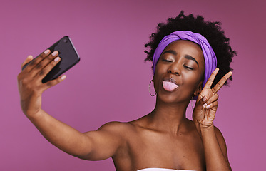 Image showing Phone, selfie and face of black woman with peace sign for wellness, fashion and cosmetics on purple background. Beauty, skincare and girl influencer on smartphone for social media, picture and post