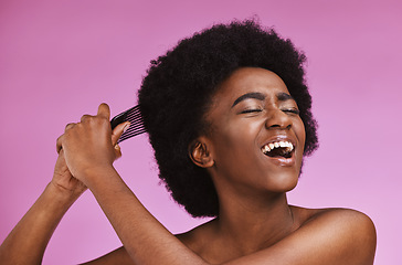 Image showing Stress, hairstyle and afro brushing on beauty studio background in grooming, texture anxiety or crisis. Black woman, comb and natural hair with damage, split ends or frizzy knots on isolated skincare