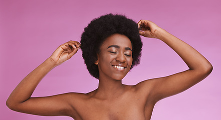 Image showing Black woman touching afro hairstyle on beauty studio background in relax skincare, texture maintenance or salon wellness. Model, natural and hair growth, hands on isolated pink or makeup backdrop.