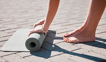 Image showing Stretching, roll and feet of woman with yoga mat for pilates, mediation and workout training. Zen, health and motivation with hands of girl on ground ready for mindfulness, relax and wellness