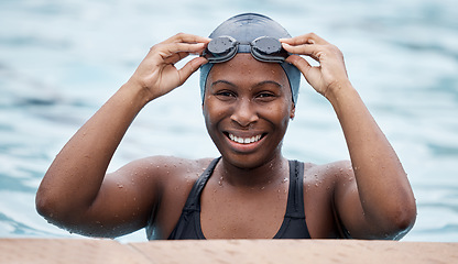 Image showing Training, portrait or happy black woman in swimming pool or water for practice, workout or body fitness. Wellness, smile or healthy girl swimmer in goggles exercising for cardio endurance or exercise