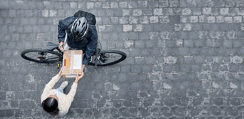 Image showing Bicycle courier, woman with box from above and package from online shopping website standing in road. Logistics, delivery and bike driver with parcel and eco friendly transport for customer in street