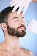 Image showing Injection, man and studio for skincare, collagen wellness and beauty process at salon. Cosmetics, face and needle of plastic surgery, botox and facial change of aesthetic prp, eyes or blue background