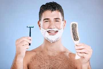 Image showing Portrait, man and brush with razor, cream and mockup with guy, hygiene and grooming on blue studio background. Face, male or gentleman with skincare, cosmetic equipment or hair removal for confidence