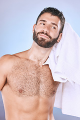 Image showing Man, shower with hygiene, towel and grooming for beauty in, smile and face in studio. Skincare, natural cosmetics and cleaning body with healthy skin, fresh and cosmetic care on blue background