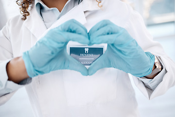 Image showing Closeup, hands and dentist with heart, woman and health for wellness, care and support. Love sign, zoom and female medical professional for dental hygiene, solidarity and innovation with blue gloves