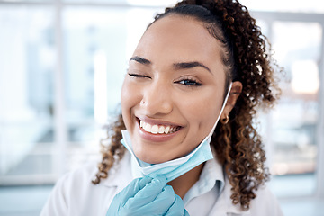 Image showing Wink, covid and portrait of doctor happy and excited with a positive mindset in the hospital after coronavirus ending. Face, medical and healthcare professional or worker smile and confident