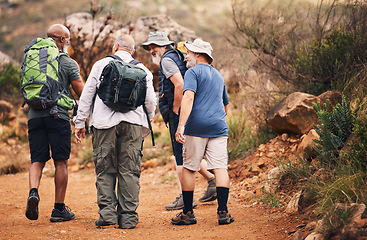 Image showing Hiking, travel and walk with old men on mountain for fitness, trekking and backpacking adventure. Explorer, discovery and group with elderly friends in nature for health, retirement and journey