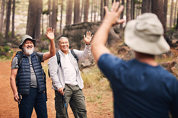 Image showing Greeting, wave and senior friends hiking in the mountains for travel, bonding and trekking in nature. Happy, group and elderly men waving for hello or goodbye while walking in the forest in Peru