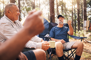 Image showing Camping, trekking and senior men with coffee in nature enjoying drink, toasting in retirement celebration or travel. Elderly friends raising cup on camp chairs for friendship adventure in the forest