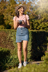 Image showing Travel, photography and woman with camera outdoor, happy in nature and picture taking while on holiday in Spain. Adventure, happiness on vacation or influencer with content creation in public garden