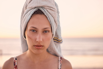 Image showing Woman, face and towel at sunset ocean, summer vacation or tropical holiday in Australia. Portrait, female and relax at beach with wet hair cloth, nature and freedom of calm lifestyle at travel resort