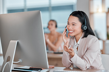 Image showing Asian woman, call center and computer with smile for telemarketing, customer support or service at office desk. Happy female consultant agent smiling in contact us for desktop advice, help or sales